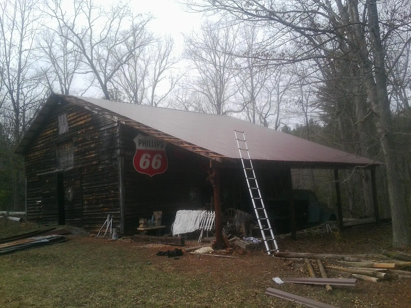 New metal roof on an open sided timber barn with a vintage sign in Auburn