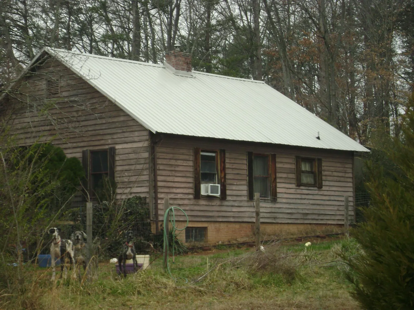 White metal roof on an old wood sided farmhouse, from a Asphalt Shingle Roof Repair job in Auburn